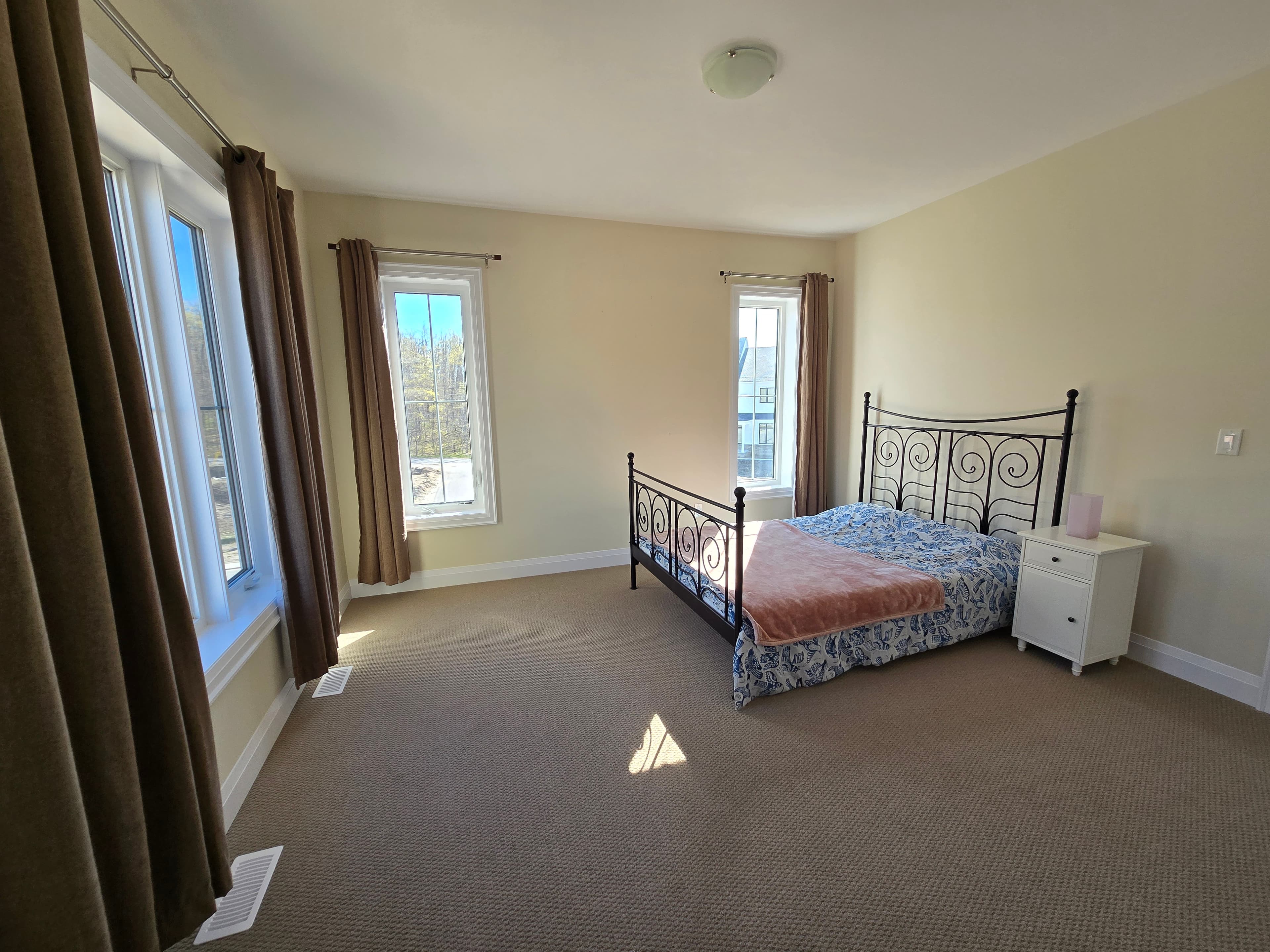 Second bedroom styled in natural linens