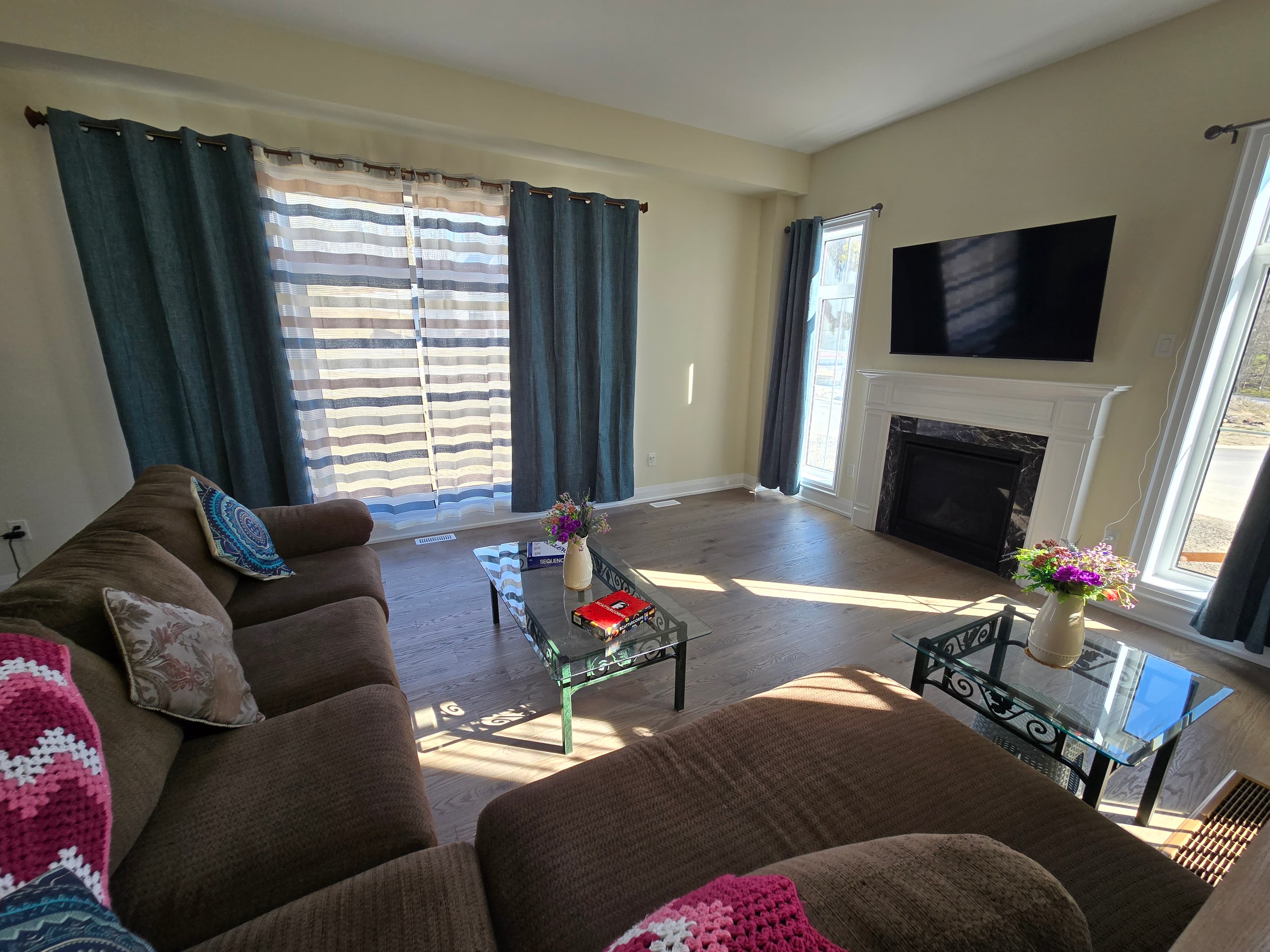 Open-concept great room with stone fireplace